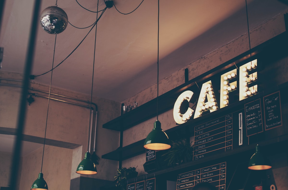 Inviting corner coffee shop with warm lighting and wooden counter